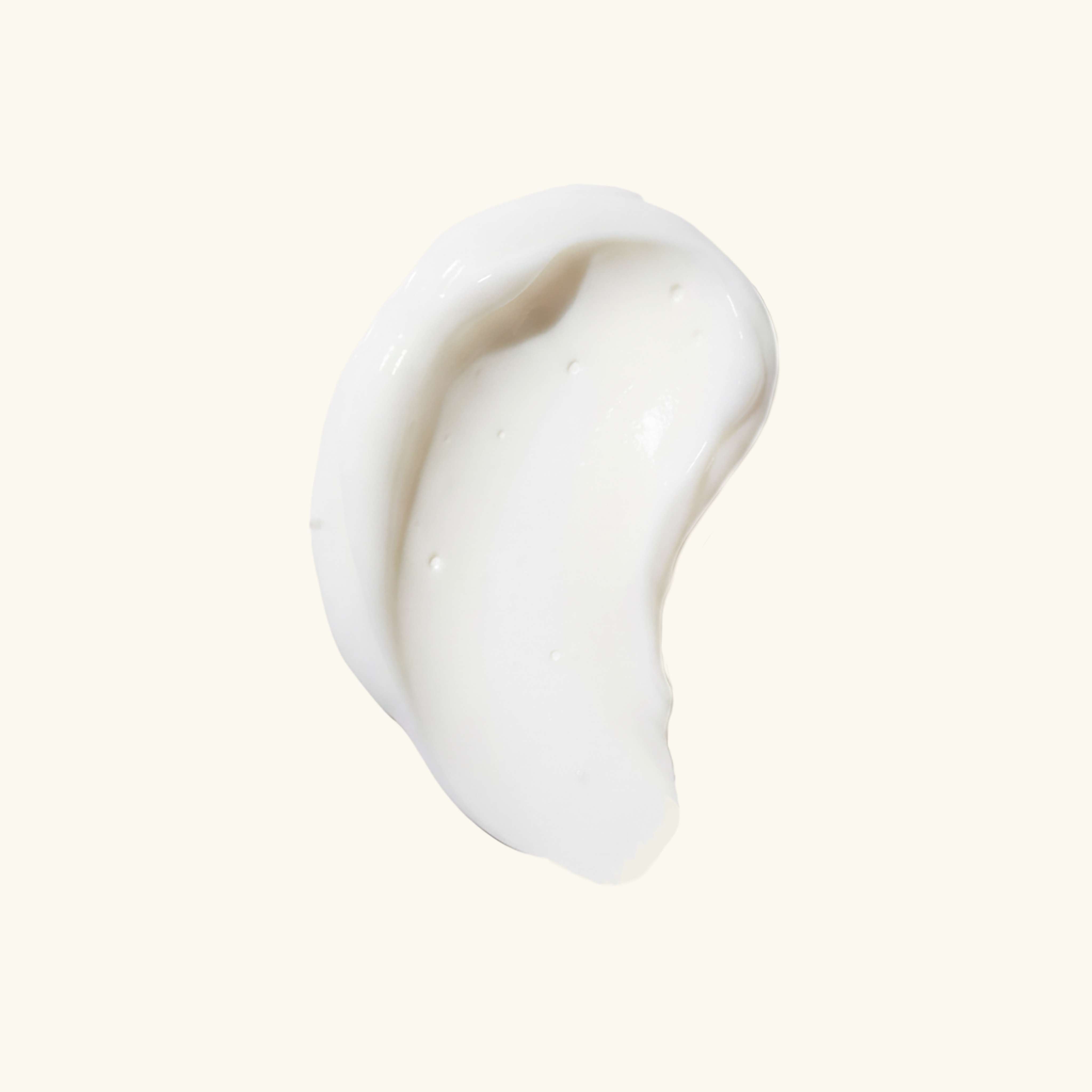 Serum swatch with a creamy white texture and smooth finish, designed to hydrate and brighten the skin