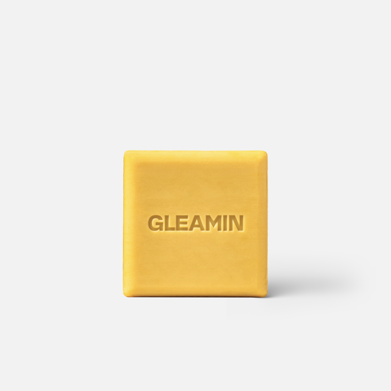 Body bar soap in vibrant yellow with GLEAMIN logo embossed, designed for cleansing and nourishing the skin