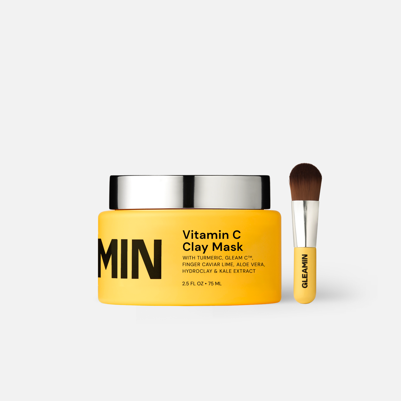 Vitamin C clay mask in a yellow jar with applicator brush designed to brighten, detoxify, and even skin tone