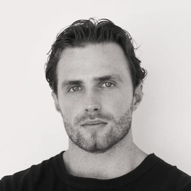 Black-and-white portrait of Jordan Smyth against a plain wall